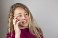 Close up portrait of blonde teenager talking in the phone