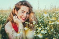 Close up portrait of blonde woman on field of daisies