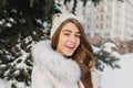 Close-up portrait of blue-eyed girl with snow in hair enjoying happy winter time. Outdoor photo of sensual blonde woman Royalty Free Stock Photo