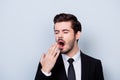 Close up portrait of bored in formal clothes yawning man isolate