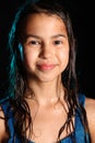 Dark-haired brown-eyed teenage girl posing in a black aqua-zone. Royalty Free Stock Photo