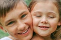 close-up portrait of brother and sister outdoors in summer