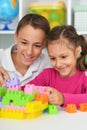 Portrait of brother and sister playing with colorful plastic blocks together Royalty Free Stock Photo