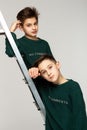 Close up portrait of brothers teenagers in green sweaters