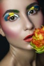 Close up portrait of Brunette woman with flawless clean skin. Creative colorful make up. Studio concept