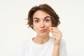 Close up portrait of brunette woman zip her lips, shows gesture to keep mouth shut, makes promise to safe someones