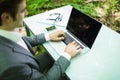 Close up portrait business man at laptop at office table hands in green forest park. Business concept. Royalty Free Stock Photo