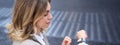 Close up portrait of business woman looking at her wrist digital watch, reading message, using app, standing outdoors in Royalty Free Stock Photo