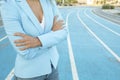 Close up portrait of business woman while standing with arms crossed on a athletics court Royalty Free Stock Photo