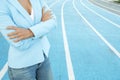 Close up portrait of business woman while standing with arms crossed on a athletics court Royalty Free Stock Photo