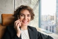 Close up portrait of businesswoman answers phone call, saleswoman having discussion with client over the telephone Royalty Free Stock Photo