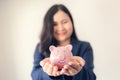 Close Up Portrait of Businesswoman Holding Piggy Bank on Her Hands, Asian Business Woman in Uniform Suit Showing Saving Money Royalty Free Stock Photo