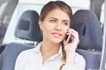 Close up portrait of a businesswoman talking on mobile phone in the car Royalty Free Stock Photo
