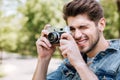 Close-up portrait of casual man making photo using camera Royalty Free Stock Photo