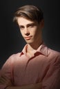 Close-up portrait of Caucasian attractive model young man wearing strip shirt standing Isolated on black background and
