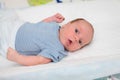 Close up portrait of caucasian cute newborn baby indoor lying on baby changing table in selective focus Royalty Free Stock Photo