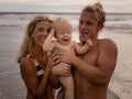 Close up portrait of caucasian family spending time on the beach. Father and mother holding infant baby boy. Happiness. Positive Royalty Free Stock Photo