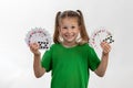 Close up portrait of caucasian girl with playing cards. Isolated on white background. Childhood concept. Free time, fun, hobby, Royalty Free Stock Photo