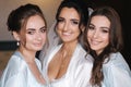 Close up portrait of charming bride with beautiful bridesmaids in blue negligee Royalty Free Stock Photo