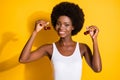 Close-up portrait of charming cheerful wavy-haired girl holding in hands cherries isolated on bright yellow color Royalty Free Stock Photo