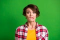 Close up portrait of charming scared person bite lips staring checkered clothing isolated on green color background