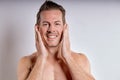 Close-up portrait of happy caucasian guy with wet sexy body posing, touching face Royalty Free Stock Photo