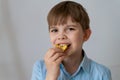 Close up portrait cheerful child having fun eating potato chips isolated Royalty Free Stock Photo