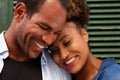 Close up cheerful couple in love smiling on green background