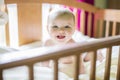 Close-up portrait of a cheerful cute baby in the crib at home Royalty Free Stock Photo