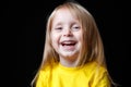 Close-up portrait of a cheerful little girl. Studio shot over dark background. Childhood concept Royalty Free Stock Photo