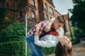 Close-up portrait of the cheerful loving couple dancing in the green street of Poland.