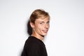 Close up portrait of cheerful smiling blond handsome young man wearing black t-shirt isolated on white background Royalty Free Stock Photo