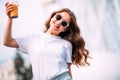Close-up portrait of cheerful white woman in glasses on blur background. Photo of fashionable girl with beautiful brown hair smili Royalty Free Stock Photo