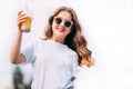 Close-up portrait of cheerful white woman in glasses on blur background. Photo of fashionable girl with beautiful brown hair smili Royalty Free Stock Photo