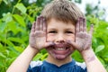 Close-up portrait of child whose face and hands are painted with black mulberry juice. Royalty Free Stock Photo