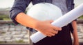 Close up portrait of civil engineer woman hand holding hardhat a