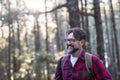 Close up portrait of confident bearded man in a outdoor park. Profile young handsome smiling bearded man Young adult hipster Royalty Free Stock Photo