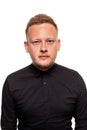 Close up portrait of a confident, blond, handsome young man wearing black shirt, isolated on white background Royalty Free Stock Photo