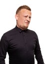 Close up portrait of a confident, blond, handsome young man wearing black shirt, isolated on white background