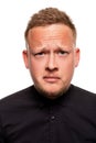 Close up portrait of a confident, blond, handsome young man wearing black shirt, isolated on white background Royalty Free Stock Photo