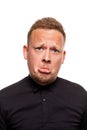 Close up portrait of a confident, blond, handsome young man wearing black shirt, isolated on white background Royalty Free Stock Photo