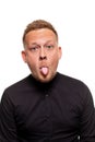 Close up portrait of a confident, blond, handsome young man wearing black shirt, isolated on white background Royalty Free Stock Photo