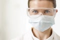 Close-up portrait of confident dentist wearing surgical mask and eyewear Royalty Free Stock Photo