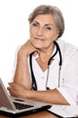 Close-up portrait of confident female doctor sitting at table with laptop Royalty Free Stock Photo