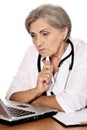 Close-up portrait of confident female doctor sitting at table with laptop Royalty Free Stock Photo