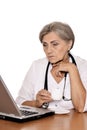 Portrait of confident female doctor sitting at table isolated Royalty Free Stock Photo