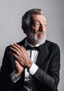 Closeup portrait of confident mature man in tuxedo isolated on black background Royalty Free Stock Photo
