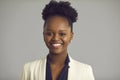 Close up portrait of confident stylish african american business woman on gray background.