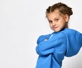 Close up portrait of a cool little girl in a blue hoodie on a white background. Royalty Free Stock Photo