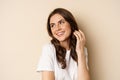 Close up portrait of coquettish beautiful girl gazing silly, gently smiling and giggling, posing flirty and cute against Royalty Free Stock Photo